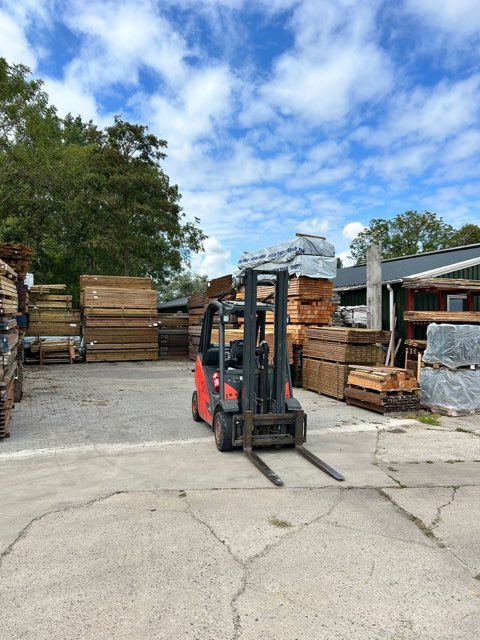De heftruck tussen de houtpakketten